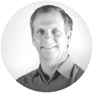 Black and white circular photo of Alan Eustace